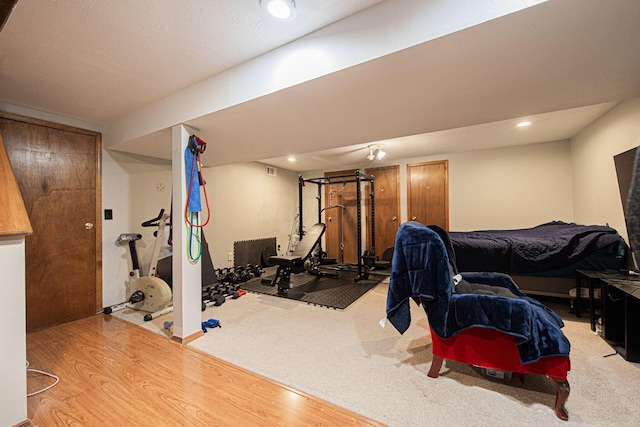 workout room with hardwood / wood-style floors