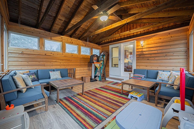 interior space with a healthy amount of sunlight, wooden ceiling, hardwood / wood-style floors, vaulted ceiling with beams, and wood walls