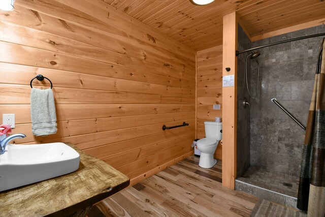 14485 Jack Run Rd, Rockbridge, OH 43149 - bathroom featuring a stall shower, wood finished floors, toilet, wooden ceiling, and wood walls