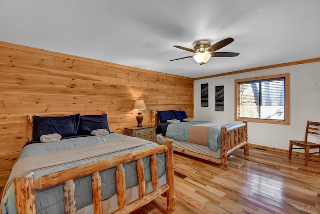 14485 Jack Run Rd, Rockbridge, OH 43149 - bedroom featuring wood finished floors, baseboards, wooden walls, and a ceiling fan