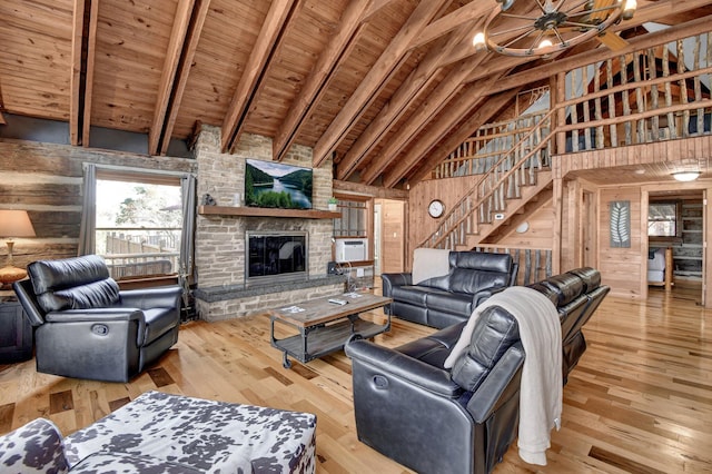 14485 Jack Run Rd, Rockbridge, OH 43149 - living area with wood walls, stairs, a fireplace, high vaulted ceiling, and wood-type flooring