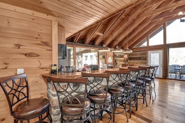 14485 Jack Run Rd, Rockbridge, OH 43149 - indoor bar with wooden walls, wood-type flooring, and vaulted ceiling