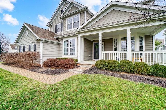 view of front of home with a front yard and a porch