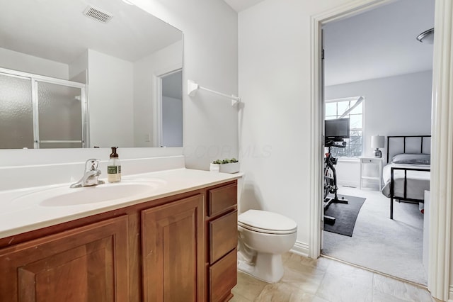 bathroom featuring vanity, toilet, and walk in shower