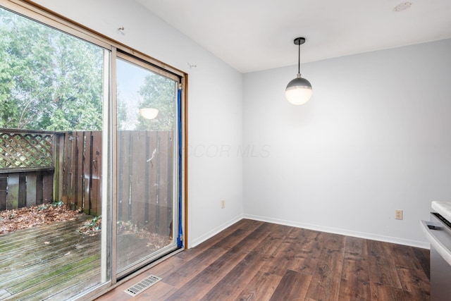 unfurnished dining area with dark wood-type flooring