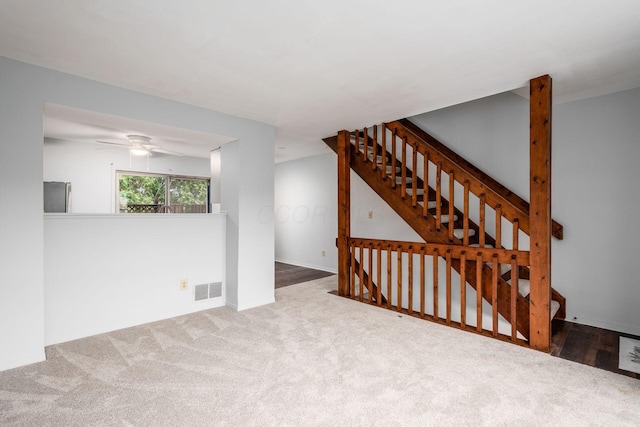 interior space with carpet and ceiling fan