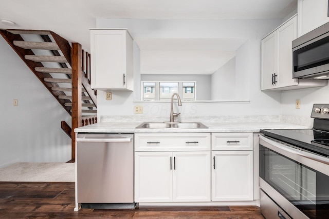 kitchen featuring sink, white cabinets, dark hardwood / wood-style floors, and appliances with stainless steel finishes