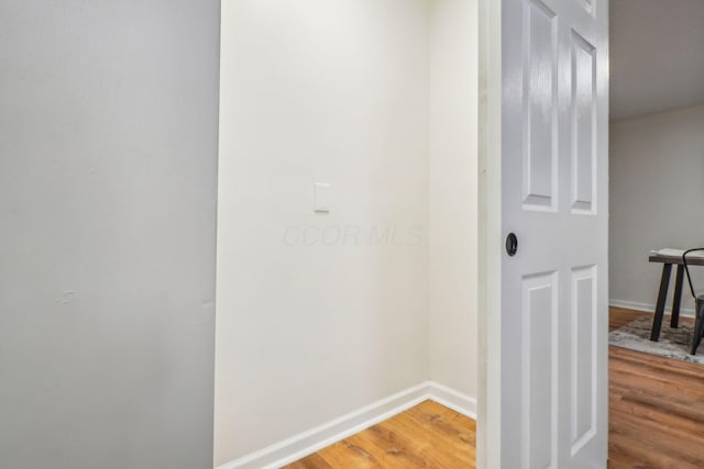 hallway with hardwood / wood-style floors