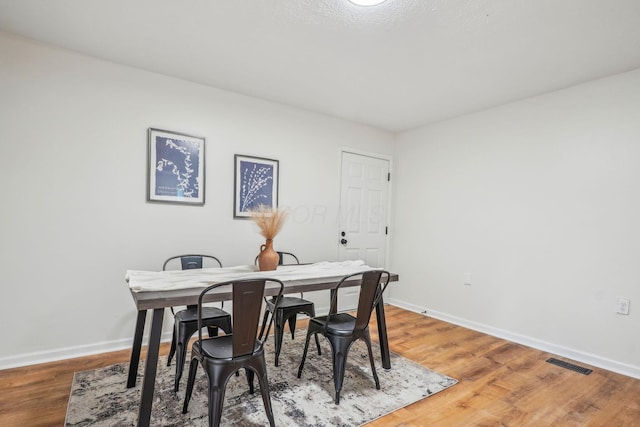 dining space featuring wood-type flooring