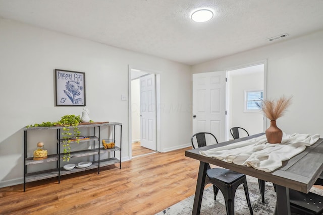 office with a textured ceiling and hardwood / wood-style flooring