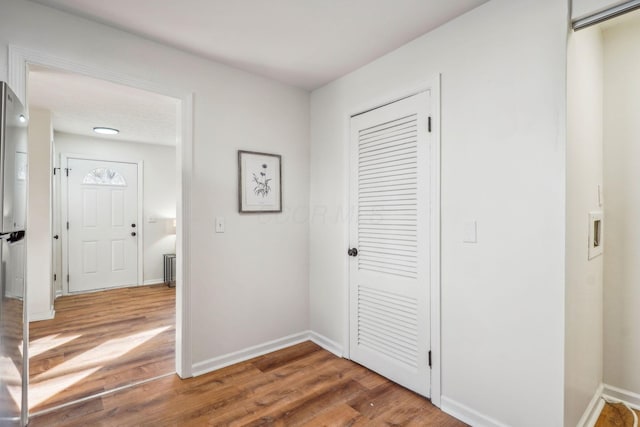 corridor with wood-type flooring