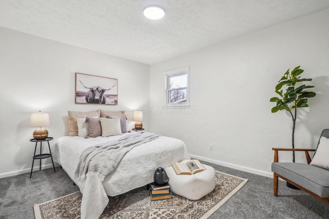 bedroom featuring dark colored carpet and a textured ceiling