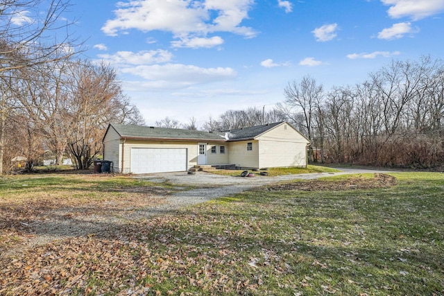 ranch-style home featuring a garage and a front lawn