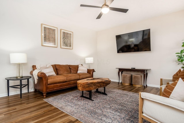 living room with dark hardwood / wood-style floors and ceiling fan