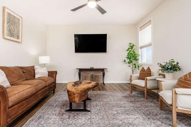 living room featuring dark hardwood / wood-style floors and ceiling fan