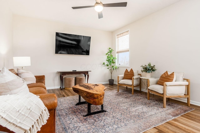 living room featuring hardwood / wood-style flooring and ceiling fan