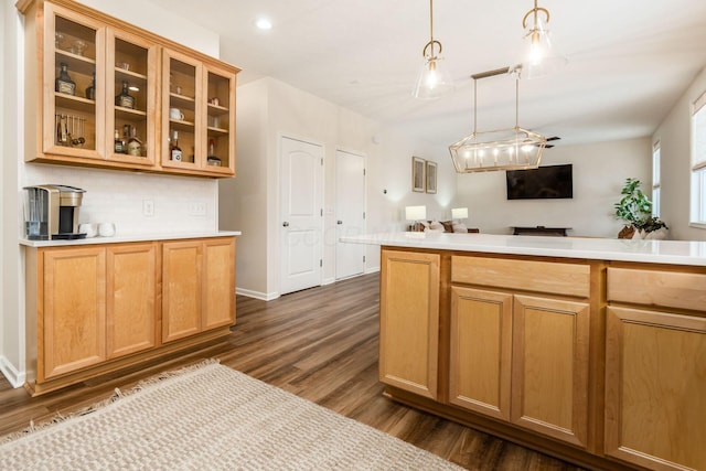 kitchen featuring decorative backsplash, hanging light fixtures, and dark wood-type flooring