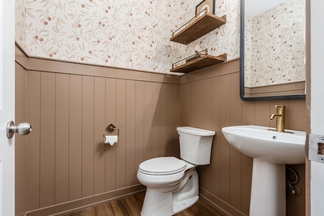 bathroom featuring hardwood / wood-style floors and toilet