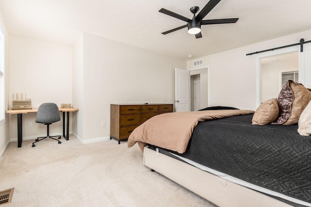 bedroom with ceiling fan and light carpet