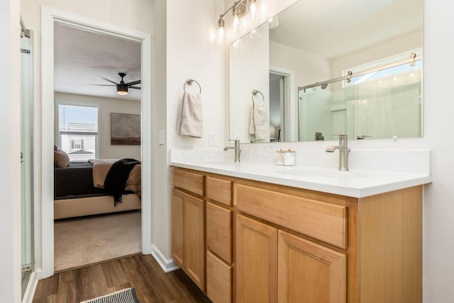 bathroom featuring ceiling fan, hardwood / wood-style floors, a textured ceiling, a shower with door, and vanity