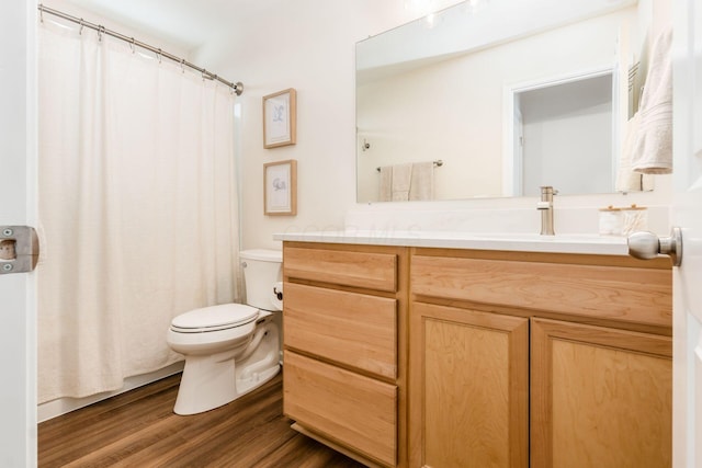 bathroom featuring toilet, vanity, and hardwood / wood-style flooring