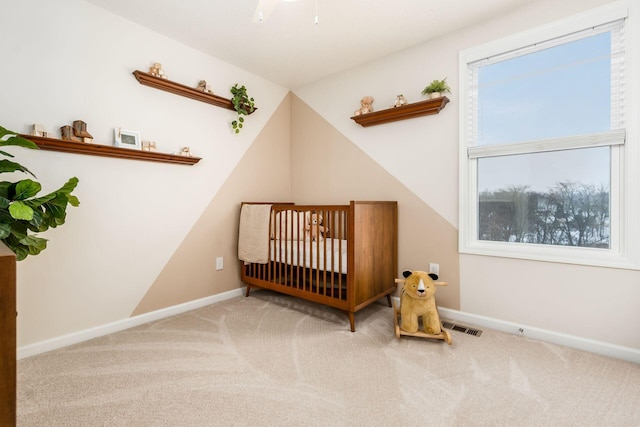 bedroom with vaulted ceiling, carpet, and a crib