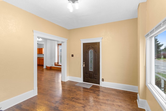 entryway featuring a textured ceiling and dark hardwood / wood-style floors