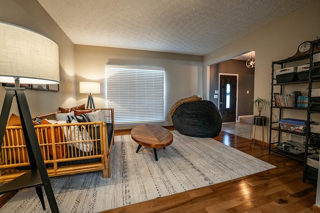 sitting room featuring dark hardwood / wood-style flooring and a textured ceiling