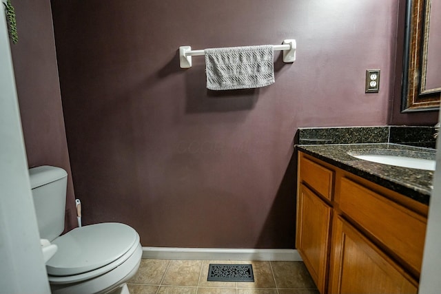 bathroom featuring tile patterned floors, vanity, and toilet