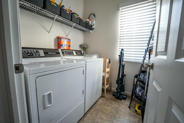 laundry area featuring separate washer and dryer and light tile patterned floors