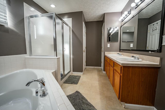 bathroom with vanity, a textured ceiling, tile patterned floors, and independent shower and bath