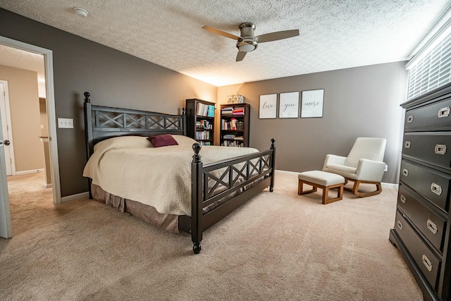 carpeted bedroom featuring a textured ceiling and ceiling fan