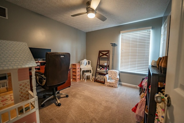 carpeted office with ceiling fan and a textured ceiling