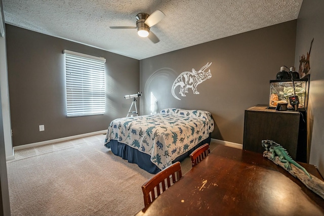 bedroom with ceiling fan, carpet, and a textured ceiling