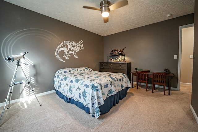 carpeted bedroom featuring ceiling fan and a textured ceiling