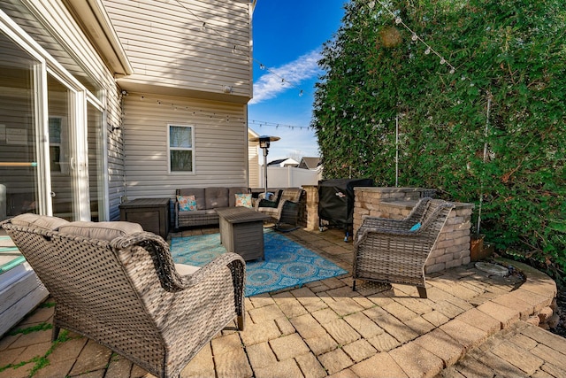 view of patio with grilling area and an outdoor hangout area