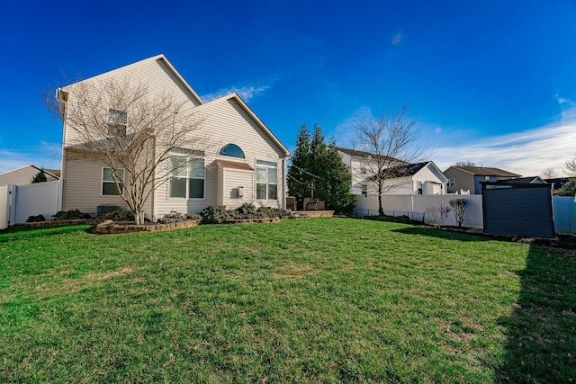 back of property featuring a lawn