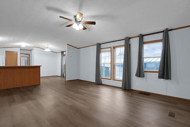 unfurnished room with ceiling fan, dark wood-type flooring, and a textured ceiling