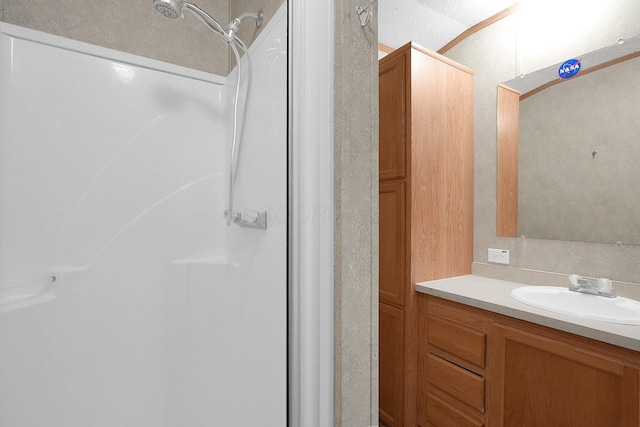 bathroom with vanity and walk in shower