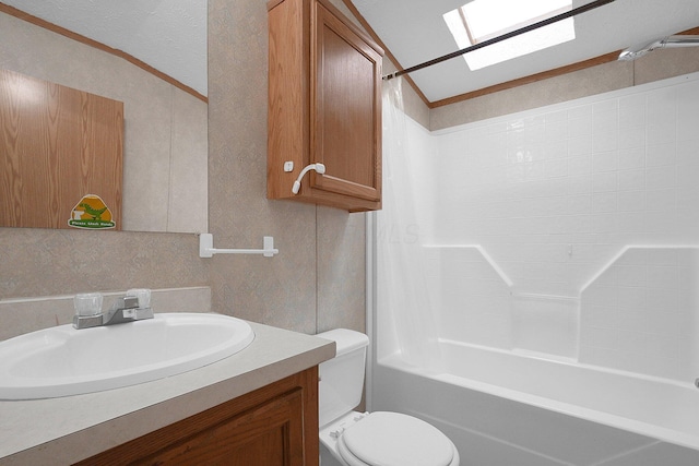 full bathroom with crown molding, toilet, vaulted ceiling with skylight, vanity, and bathtub / shower combination