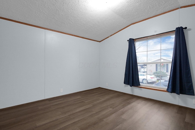 spare room with hardwood / wood-style flooring, ornamental molding, a textured ceiling, and vaulted ceiling