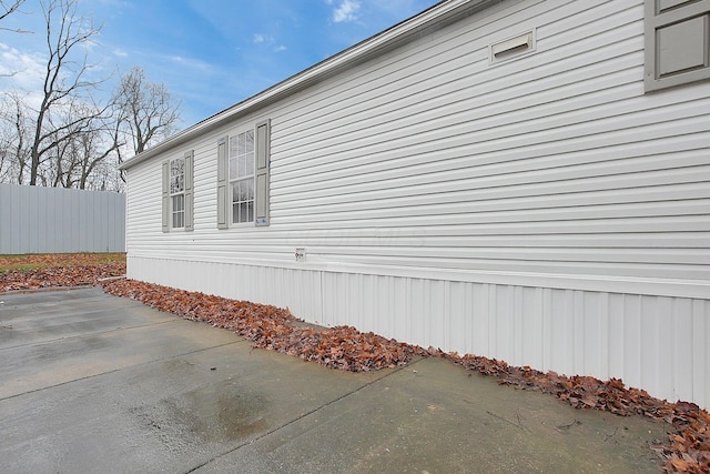 view of property exterior with a patio area