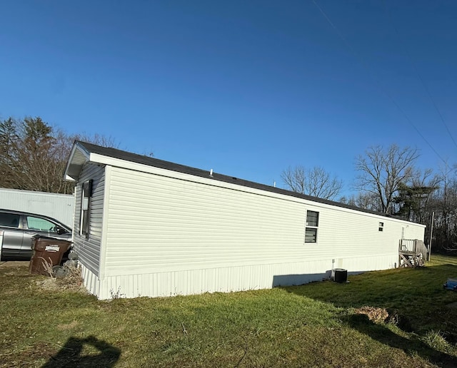 view of side of property with a yard