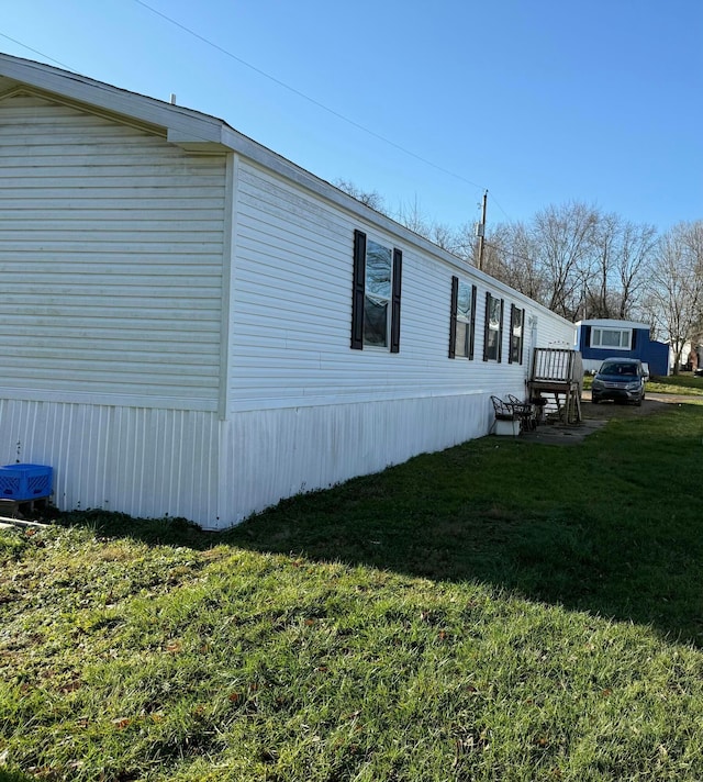 view of side of property with a lawn