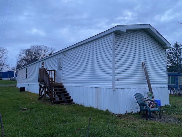 view of home's exterior with a yard