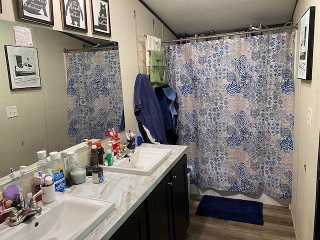 bathroom featuring hardwood / wood-style floors, vanity, and curtained shower