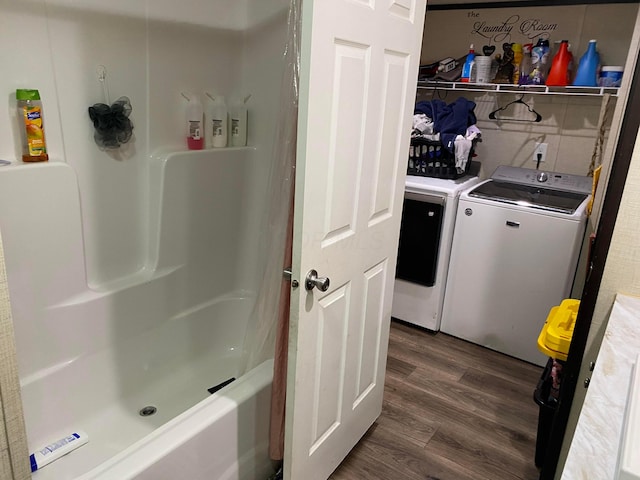 clothes washing area featuring separate washer and dryer and dark hardwood / wood-style flooring