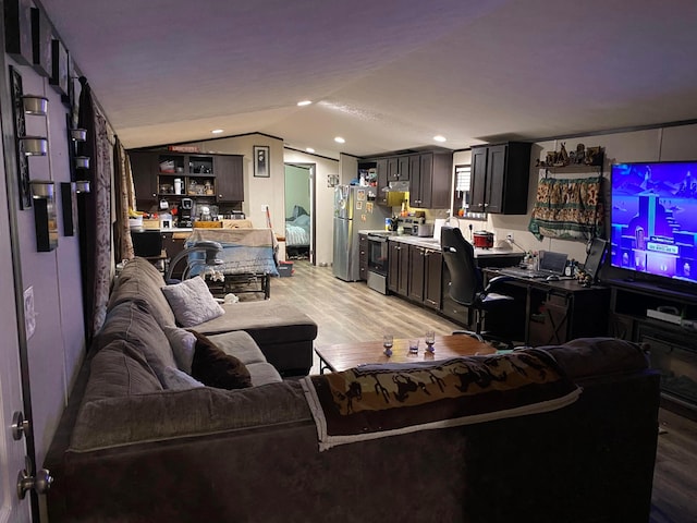 living room featuring light hardwood / wood-style floors and vaulted ceiling