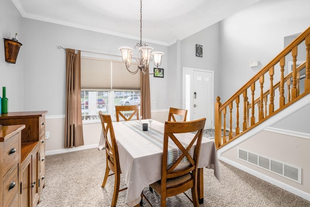 dining room featuring light carpet, a chandelier, and ornamental molding