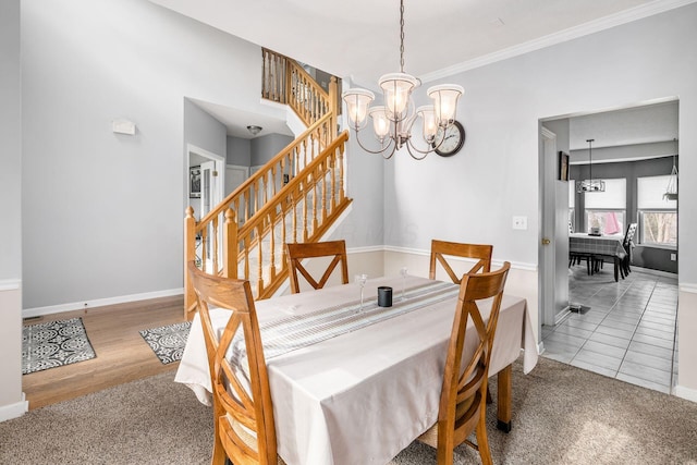 dining space with carpet flooring, an inviting chandelier, and crown molding